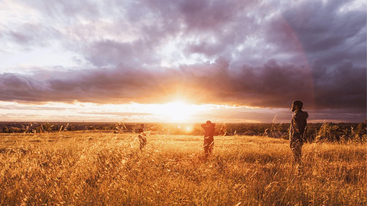 Participants in an outdoor exercise at sunset